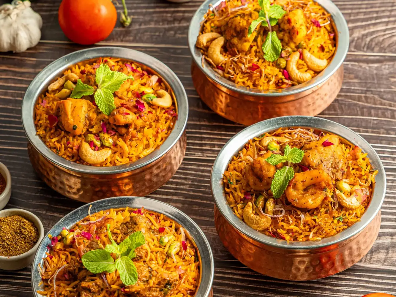 Chicken and prawn biryani in copper bowls with mint, cashews and spices at Al Saray, a halal restaurant in Bangkok